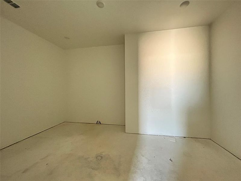 The main closet boasts high ceilings, ideal for designing a custom closet system. This spacious layout allows for ample storage and creative organization options.