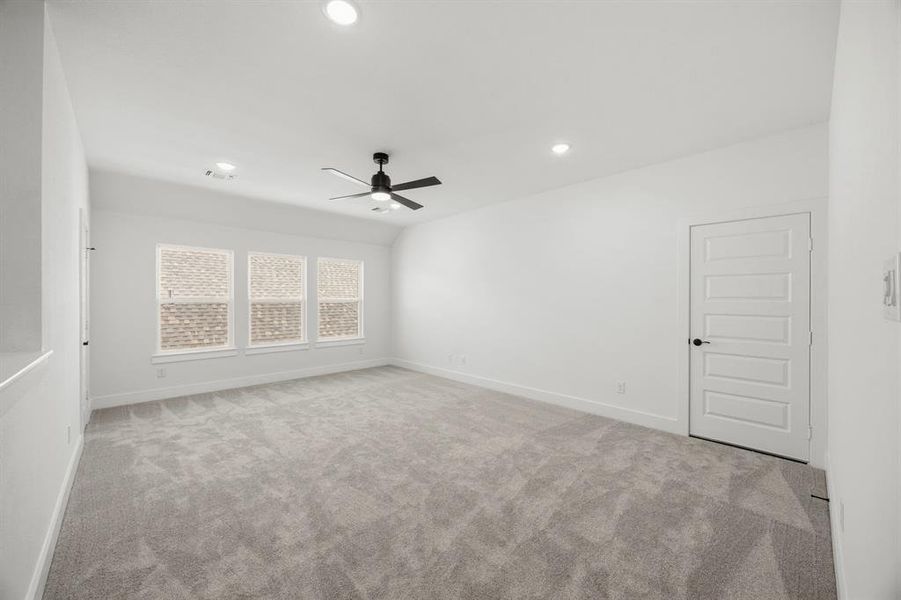 Unfurnished room featuring light colored carpet, ceiling fan, and recessed lighting