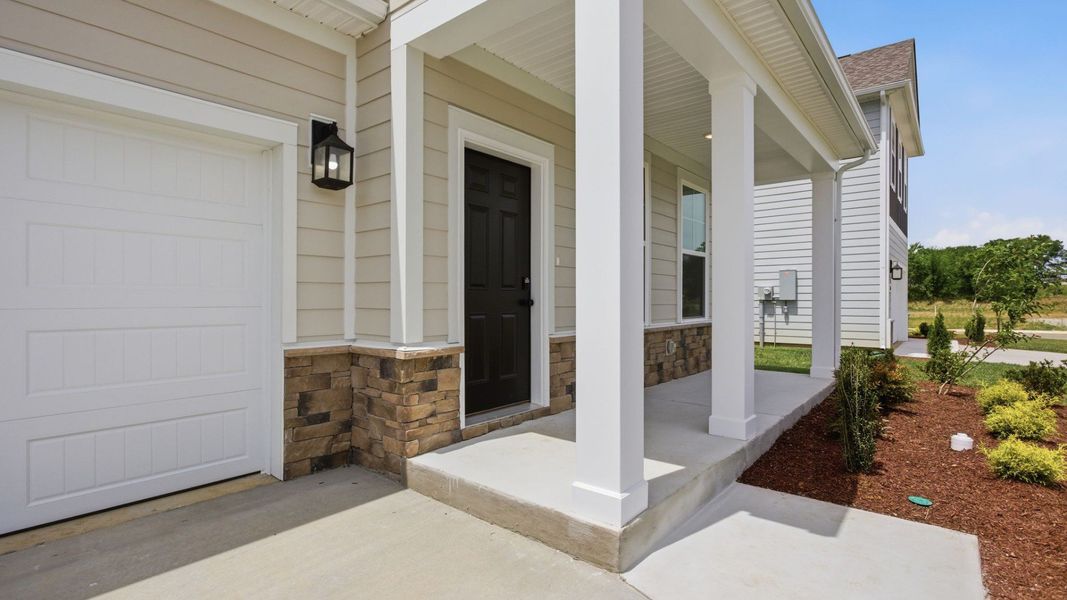 Covered entryway to home with black door Covered entryway to home with black door