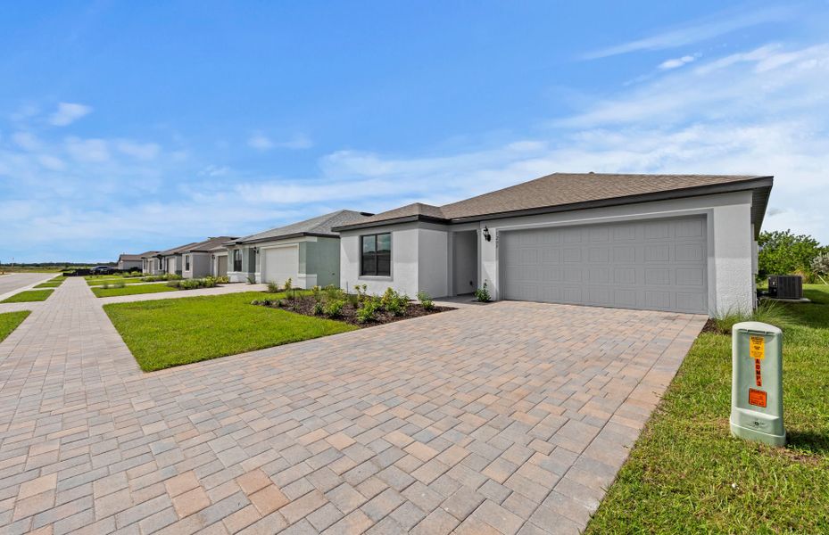 Front exterior of a new home in Caloosa Cove, Labelle, FL, highlighting curb appeal (Image 2).