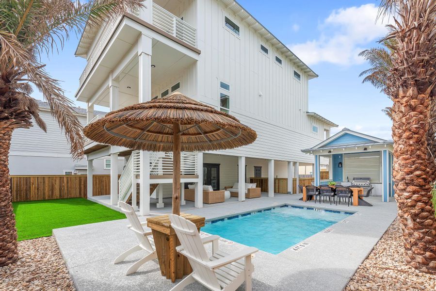 Rear view of property with an outdoor hangout area, board and batten siding, a patio area, and outdoor dining space Rear view of property with an outdoor hangout area, board and batten siding, a patio area, and outdoor dining space