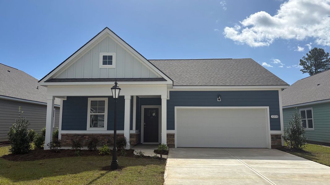 Front exterior of a new home in Rich Square at Brunswick Plantation, Ash, NC, highlighting curb appeal (Image 1).