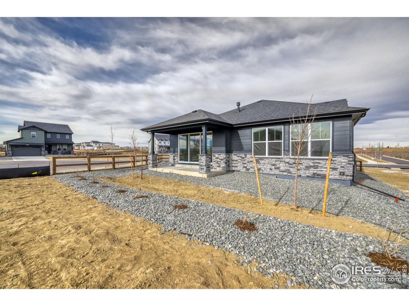 Exterior details and patio area of a home in Barefoot Lakes, Firestone (Image 19).
