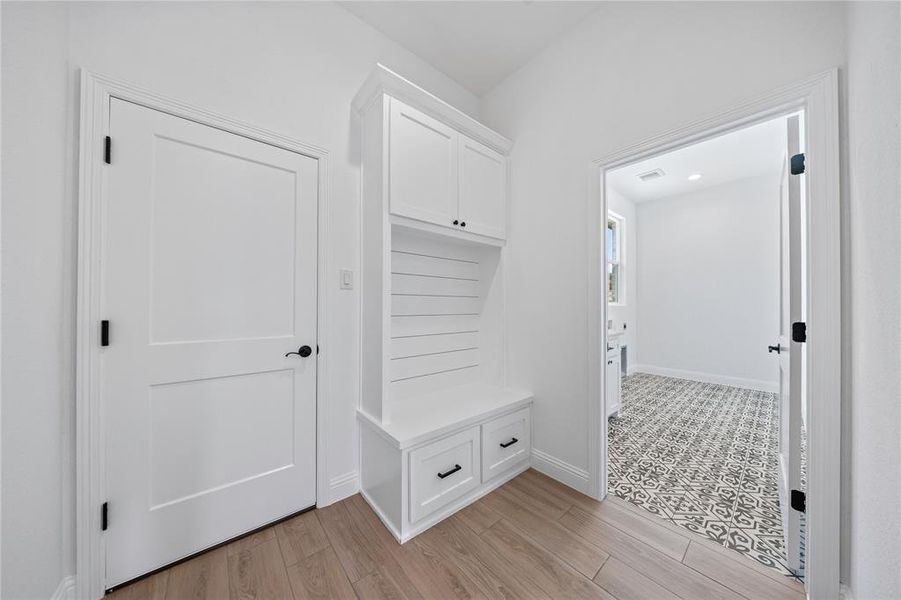 Mudroom with baseboards and light wood finished floors