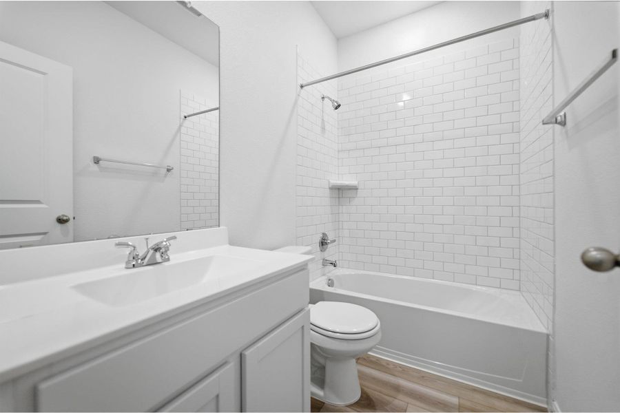 Full bath with vanity, light wood-style floors, and shower / bathtub combination Full bath with vanity, light wood-style floors, and shower / bathtub combination