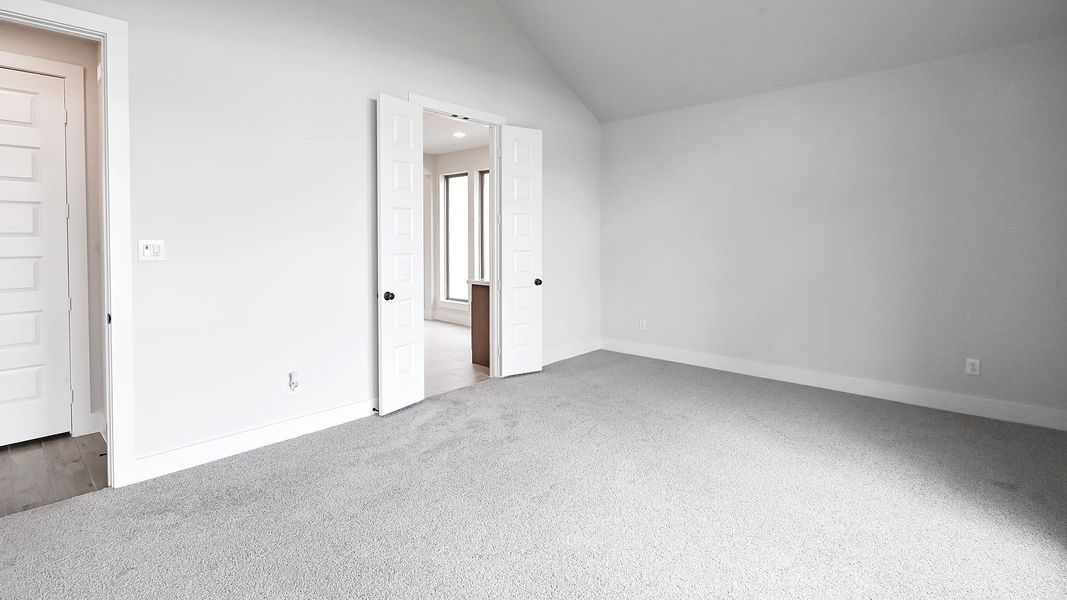 Unfurnished bedroom featuring dark carpet, recessed lighting, and vaulted ceiling Unfurnished bedroom featuring dark carpet, recessed lighting, and vaulted ceiling