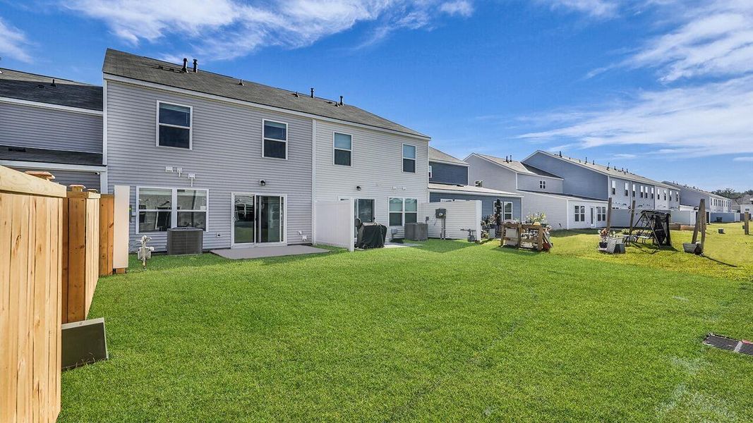 Exterior details and patio area of a home in Pine Hills Townhomes at Cane Bay, Summerville (Image 22).