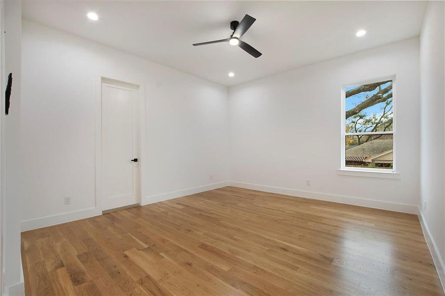 Empty room featuring light wood finished floors, baseboards, ceiling fan, and recessed lighting Empty room featuring light wood finished floors, baseboards, ceiling fan, and recessed lighting
