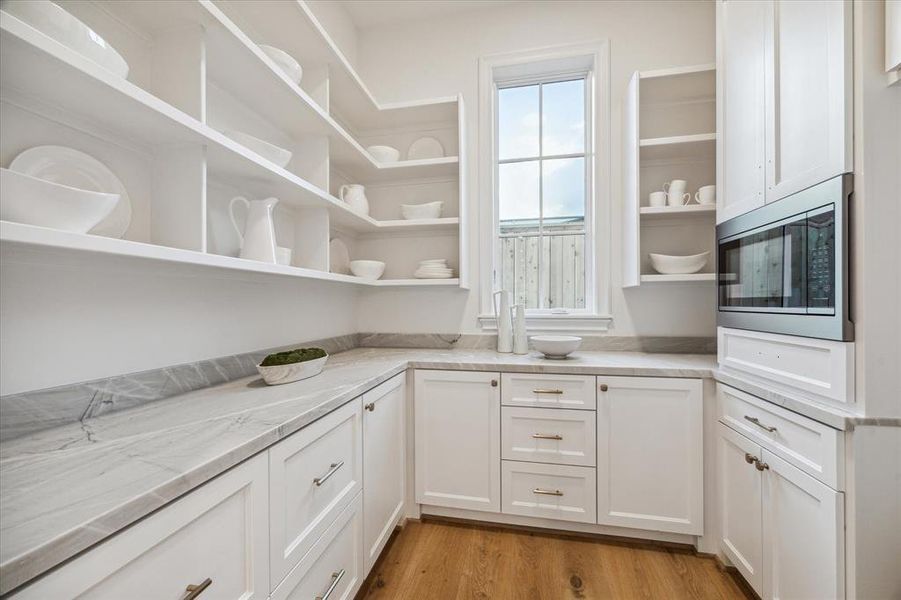 Working pantry with gorgeous built-ins and stylish open shelving off of the kitchen