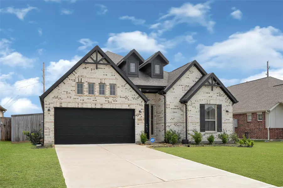 Front exterior of a new home in Oakwood Estates, Waller, TX, highlighting curb appeal (Image 2). Front exterior of a new home in Oakwood Estates, Waller, TX, highlighting curb appeal (Image 2).