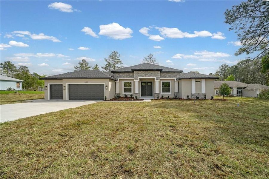 Front exterior of a new home in , Weeki Wachee, FL, highlighting curb appeal (Image 32).