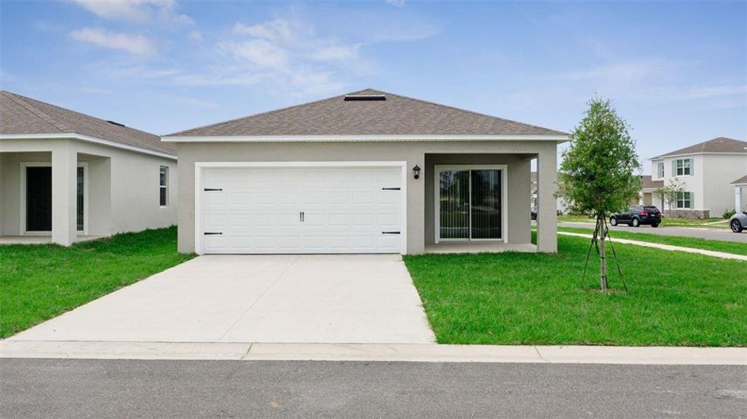 Front exterior of a new home in Crossroads at Kelly Park, Apopka, FL, highlighting curb appeal (Image 2).