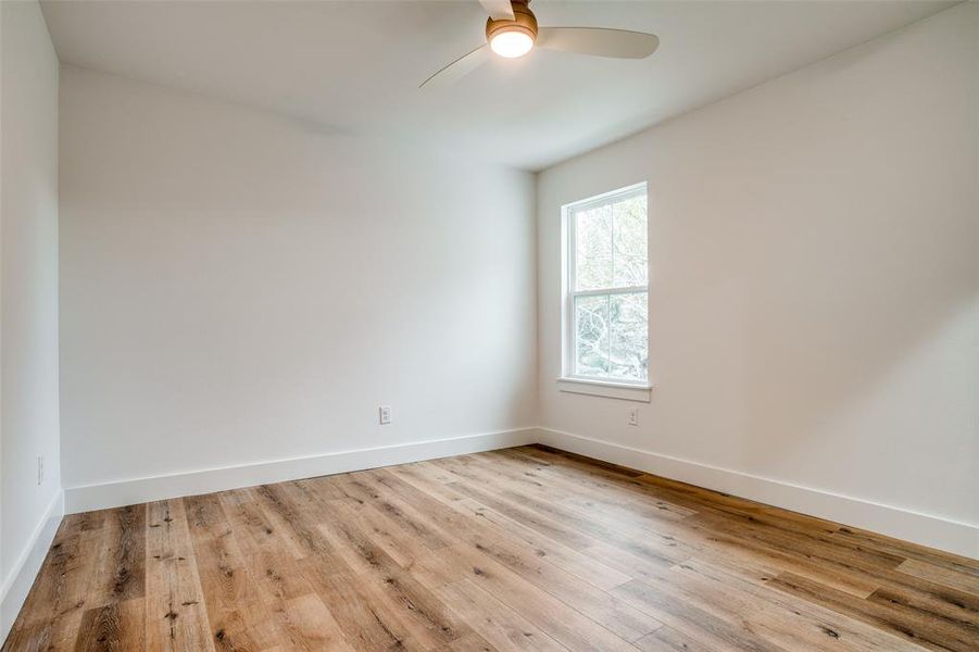 Spare room with ceiling fan and light hardwood / wood-style floors