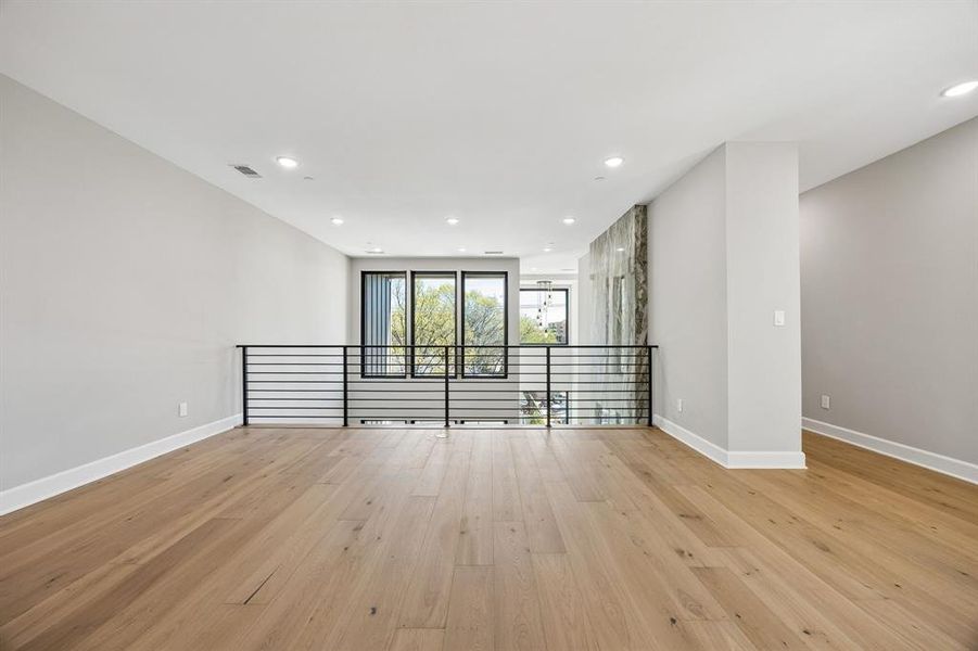 Unfurnished room featuring light wood-style floors and recessed lighting Unfurnished room featuring light wood-style floors and recessed lighting