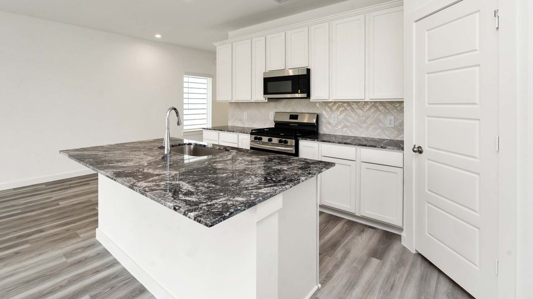 Representative furnished interior of a home built from the Jasmine by D.R. Horton in Grand West, Houston (Image 7).