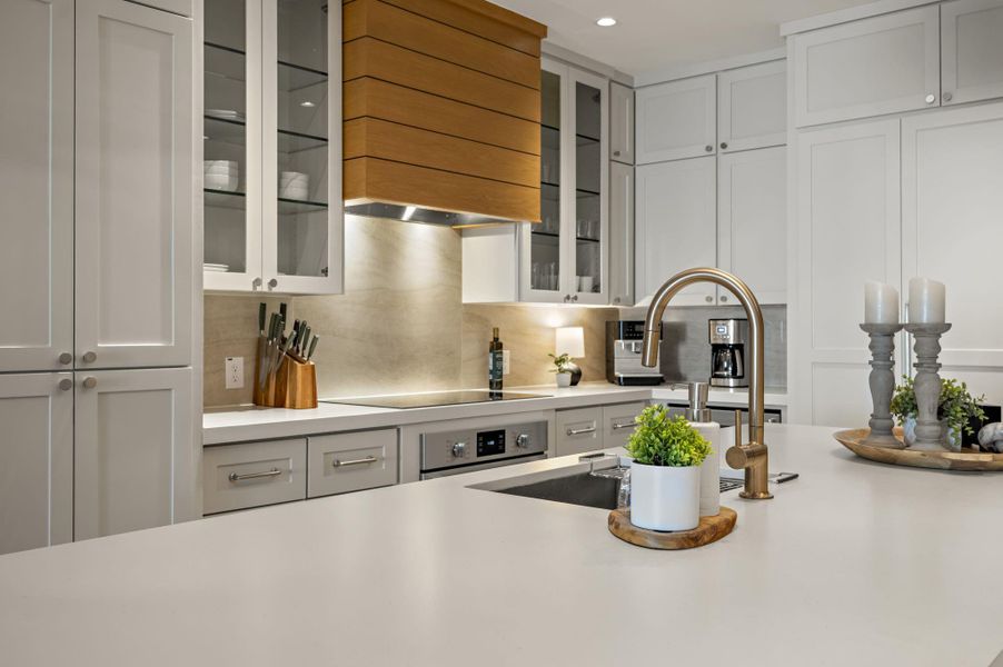 Culinary excellence awaits in this well-appointed kitchen, featuring a central island with a modern sink and ample counter space.