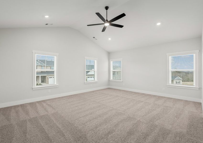 Large master bedroom with a ceiling fan.