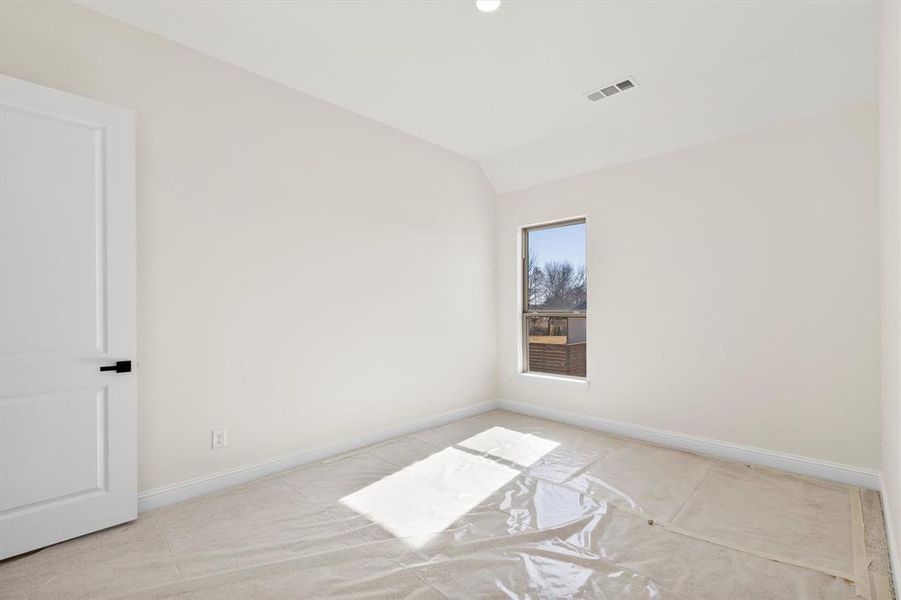 Bedroom featuring lofted ceiling