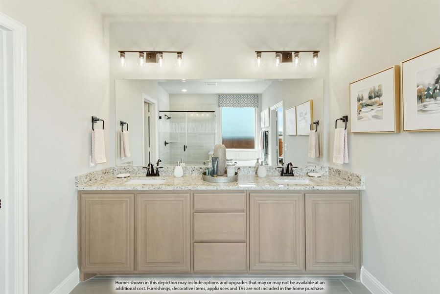 Bathroom with double vanity, granite countertops, light wood cabinets, and large mirror with dual overhead lights Bathroom with double vanity, granite countertops, light wood cabinets, and large mirror with dual overhead lights