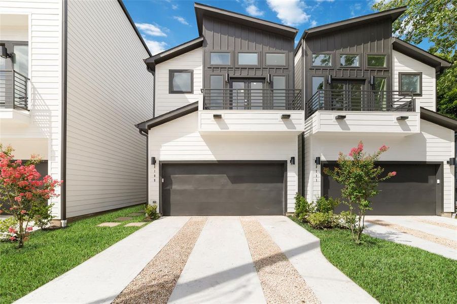This photo showcases a modern, two-story townhouse with a sleek, contemporary design. It features a double garage, clean white exterior with dark accents, and a small landscaped front yard. The property includes a balcony and large windows, allowing for ample natural light. This photo showcases a modern, two-story townhouse with a sleek, contemporary design. It features a double garage, clean white exterior with dark accents, and a small landscaped front yard. The property includes a balcony and large windows, allowing for ample natural light.