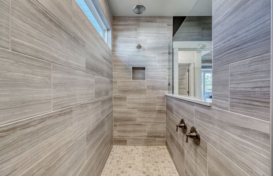 Owner's Walk-In Shower exudes luxury with its spacious design, featuring elegant fixtures and premium materials.