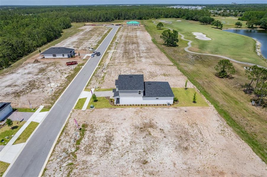 Front exterior of a new home in Gray Hawk at Hole Two, Daytona Beach, FL, highlighting curb appeal (Image 37). Front exterior of a new home in Gray Hawk at Hole Two, Daytona Beach, FL, highlighting curb appeal (Image 37).