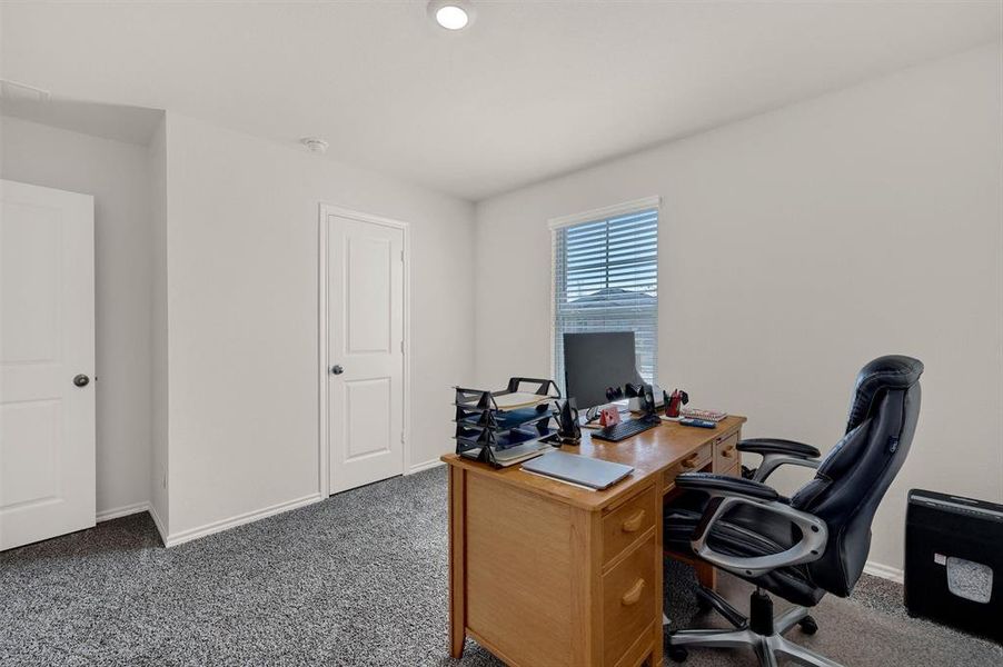 Carpeted office featuring baseboards