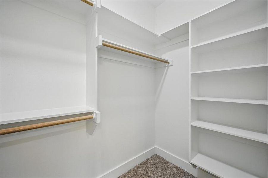 Walk in closet with carpet floors Walk in closet with carpet floors