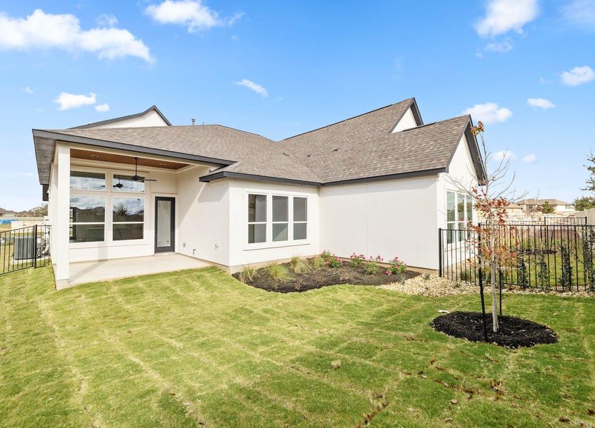 Rear view of house featuring a shingled roof, a patio area, a yard, stucco siding, and fence Rear view of house featuring a shingled roof, a patio area, a yard, stucco siding, and fence