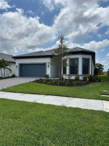 Front exterior of a new home in Lakespur Wellen Park, Venice, FL, highlighting curb appeal (Image 1).