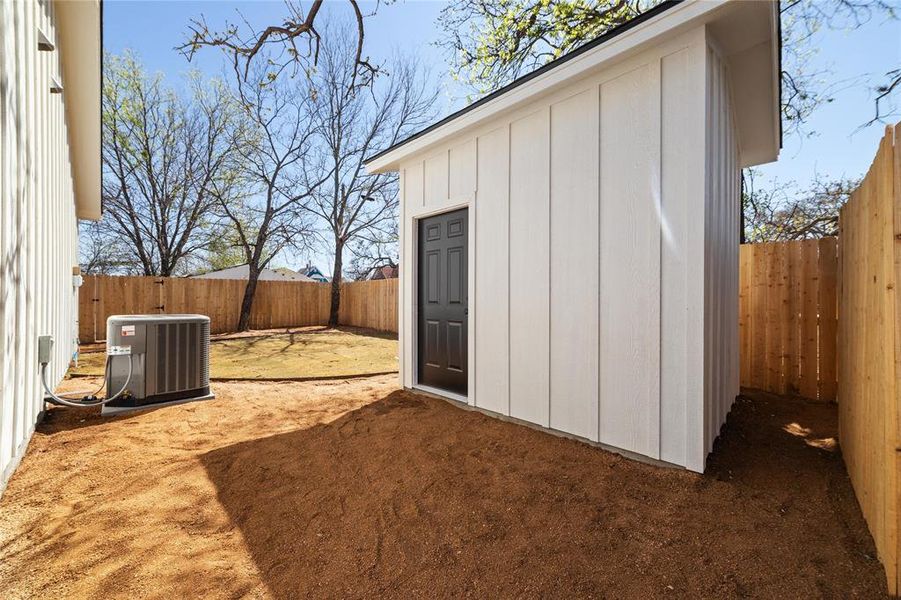 View of outdoor structure featuring a fenced backyard, an outbuilding, and central air condition unit View of outdoor structure featuring a fenced backyard, an outbuilding, and central air condition unit