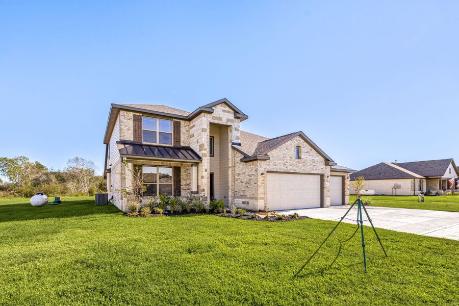 Front exterior of a new home in Southfork Ranch, Sealy, TX, highlighting curb appeal (Image 24).