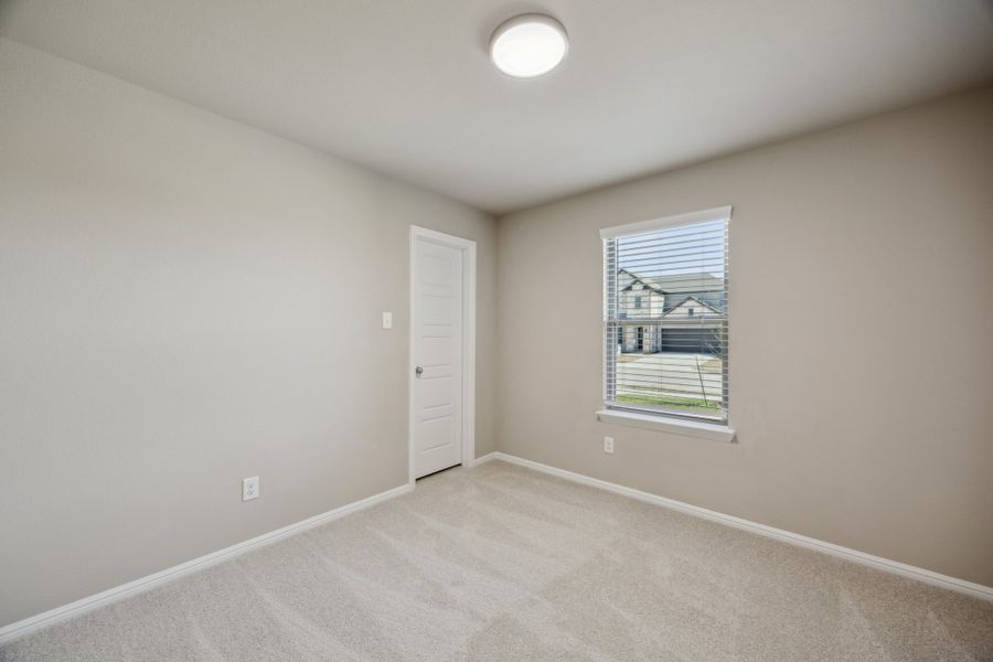 Bedroom in the Harper home plan by Trophy Signature Homes – REPRESENTATIVE PHOTO