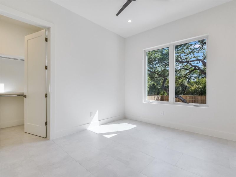 Unfurnished bedroom with recessed lighting, a closet, ceiling fan, and baseboards