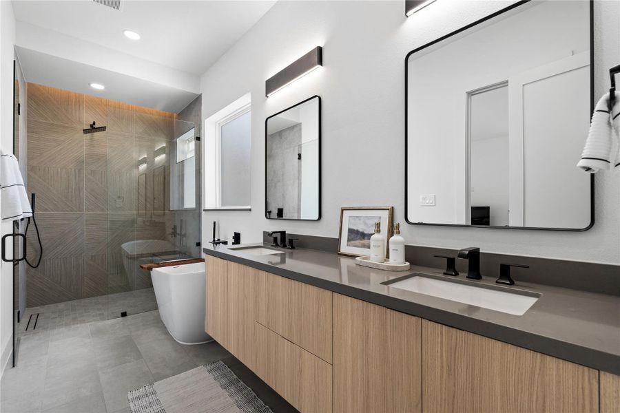 A spa-caliber composition: a floating oak vanity stretches beneath sculptural mirrors, while a freestanding soaking tub rests beside a zero-threshold, frameless shower wrapped in large-format, parquet-pattern tile. Subtle LED wash lighting and matte-black fittings sharpen the silhouette—an elevated suite for unhurried rituals and end-of-day exhale. A spa-caliber composition: a floating oak vanity stretches beneath sculptural mirrors, while a freestanding soaking tub rests beside a zero-threshold, frameless shower wrapped in large-format, parquet-pattern tile. Subtle LED wash lighting and matte-black fittings sharpen the silhouette—an elevated suite for unhurried rituals and end-of-day exhale.