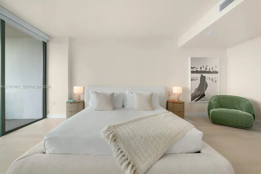 Full-height glass sliding door, neutral flooring, and recessed ceiling lighting Full-height glass sliding door, neutral flooring, and recessed ceiling lighting