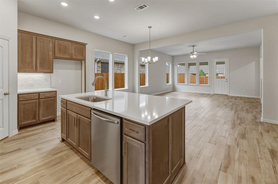 Spacious kitchen island with a built-in sink and stainless steel dishwasher