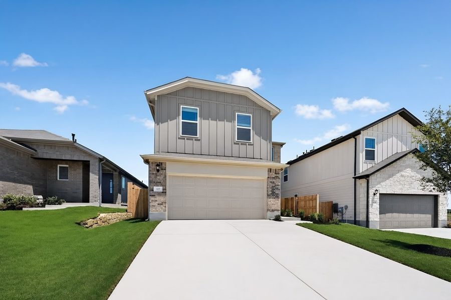 Front exterior of a new home in Sunfield, Buda, TX, highlighting curb appeal (Image 2). Front exterior of a new home in Sunfield, Buda, TX, highlighting curb appeal (Image 2).