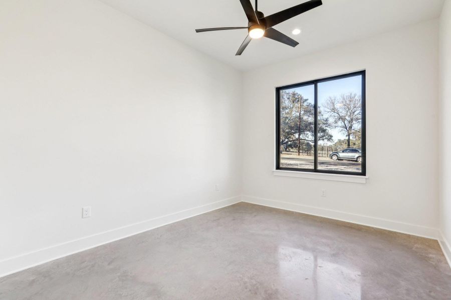 The second level features a spacious guest bedroom that provides essential versatility, making it perfect for a roommate, a secluded home office, or a private suite for visitors