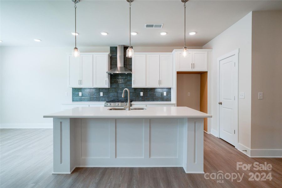 Kitchen features large, trimmed island