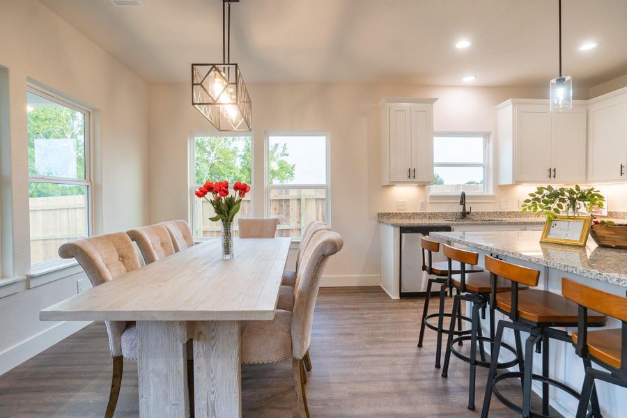 Dining room with dark wood-style floors, recessed lighting, and baseboards
