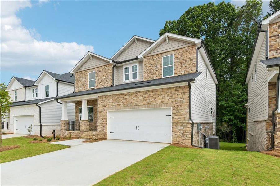 Front exterior of a new home in Martin Springs - Estate Series, Lawrenceville, GA, highlighting curb appeal (Image 25). Front exterior of a new home in Martin Springs - Estate Series, Lawrenceville, GA, highlighting curb appeal (Image 25).