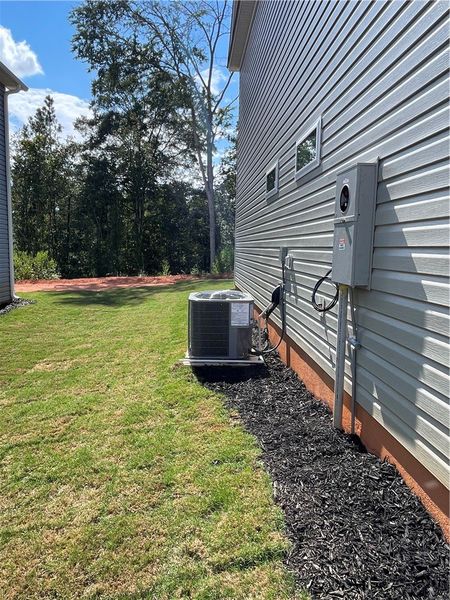 Exterior details and patio area of a home in Springwood Grove, Central (Image 7).