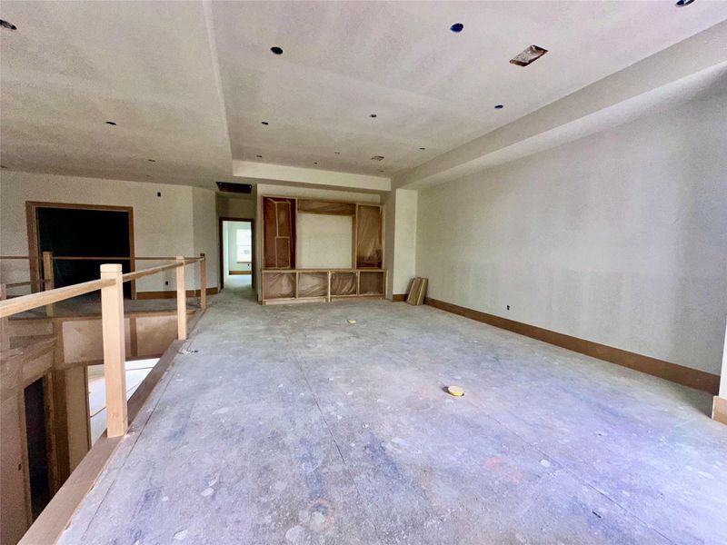 Family room upstairs with doors leading to balcony behind photographer Family room upstairs with doors leading to balcony behind photographer