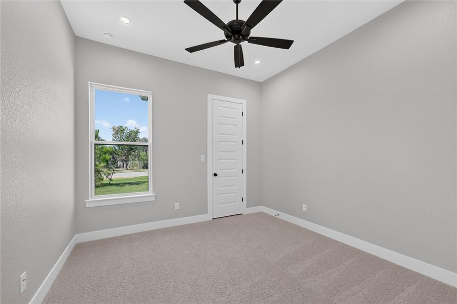 Soft carpet and a tall window bring warmth and daylight into this tranquil bedroom.