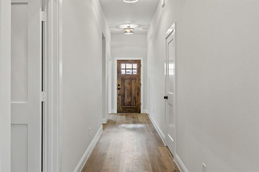 Entryway with baseboards and hardwood / wood-style floors