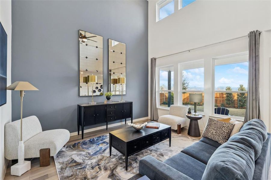 Living room featuring wood-type flooring and a high ceiling