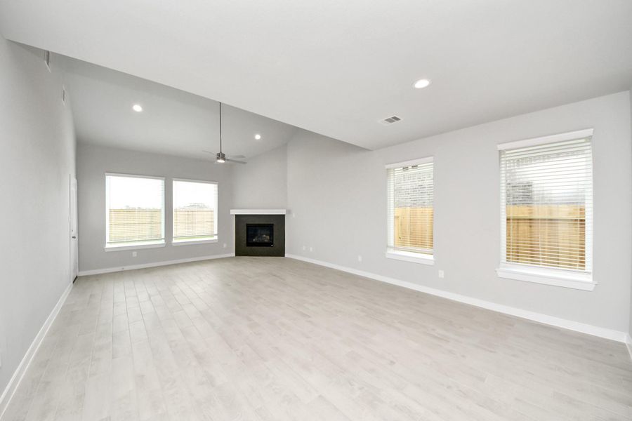 Family room flooded with natural light through the expansive windows. The premium tile flooring adds a touch of luxury to the space, creating the perfect setting for relaxing moments and cherished gatherings with loved ones. Sample photo of completed home with similar floor plan. Actual colors and selections may vary. Family room flooded with natural light through the expansive windows. The premium tile flooring adds a touch of luxury to the space, creating the perfect setting for relaxing moments and cherished gatherings with loved ones. Sample photo of completed home with similar floor plan. Actual colors and selections may vary.