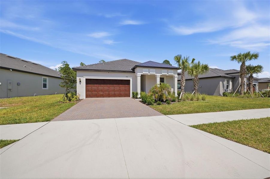 Front exterior of a new home in Angeline Active Adult, Land O' Lakes, FL, highlighting curb appeal (Image 22).