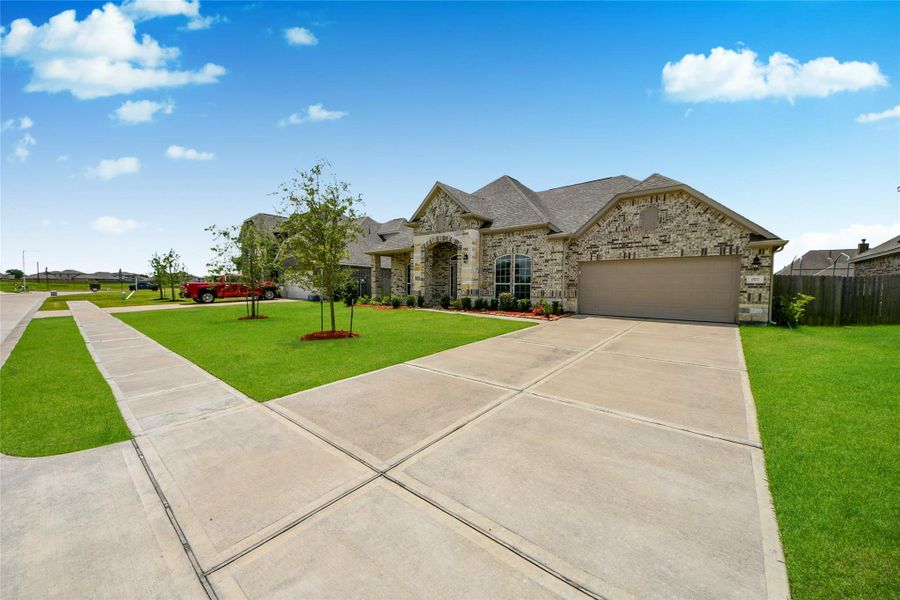 Front exterior of a new home in Elm Estates, Angleton, TX, highlighting curb appeal (Image 26).